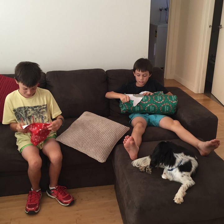 The author's sons opening Christmas gifts in a previous year, when they spent the holidays apart.