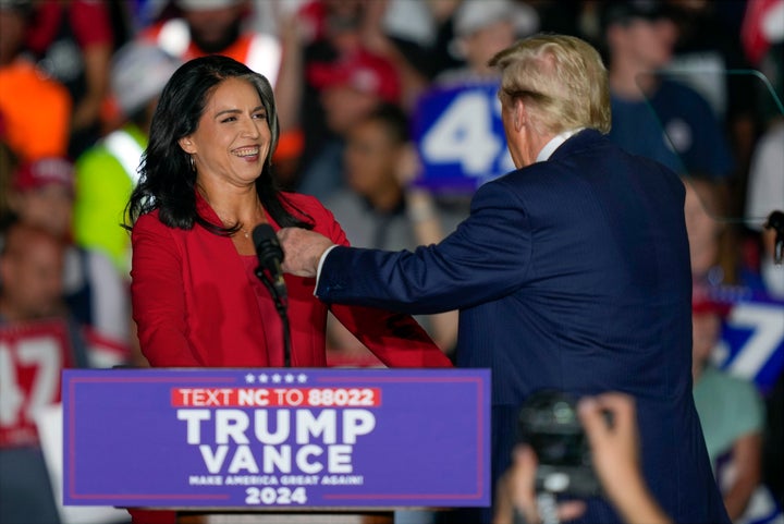 Donald Trump welcomes Tulsi Gabbard during a campaign rally at Greensboro Coliseum on Oct. 22, 2024, in Greensboro, North Carolina.