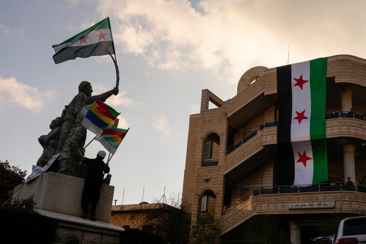 People attend a rally celebrating the fall of Syrian President Bashar al-Assad's government in the Israeli-occupied Golan Heights town of Majdal Shams, on Dec. 8, 2024.