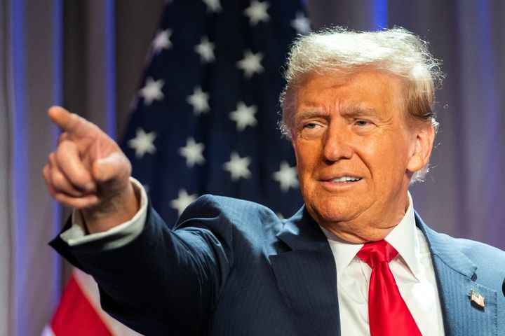 US President-elect Donald Trump gestures while speaking during a meeting with House Republicans