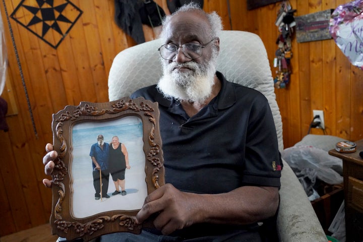 Kenny Pollard, 75, holds a photo in his home from a vacation that he and his wife, Elizabeth Pollard, took to Clearwater Beach, Florida, approximately 10 years ago.