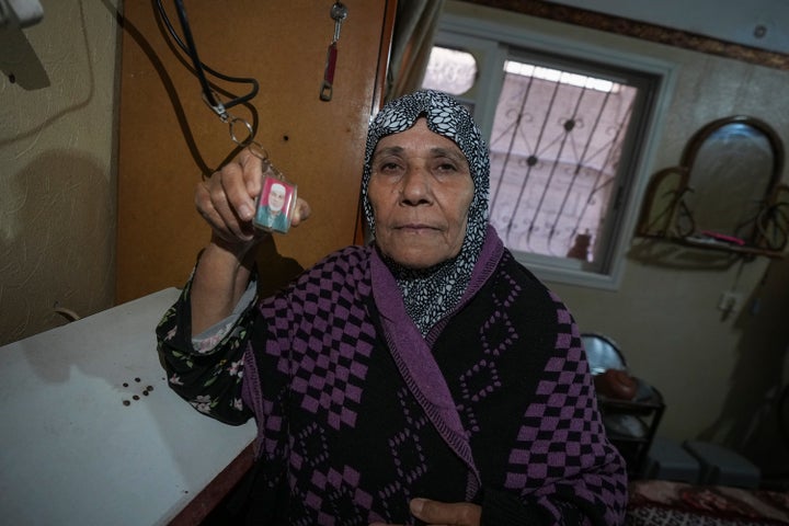 Sabah Alghrabli shows a key chain with a picture of her missing husband, Mahmoud Alghrabli, at her home in Khan Younis, Gaza Strip, Nov. 21, 2024.