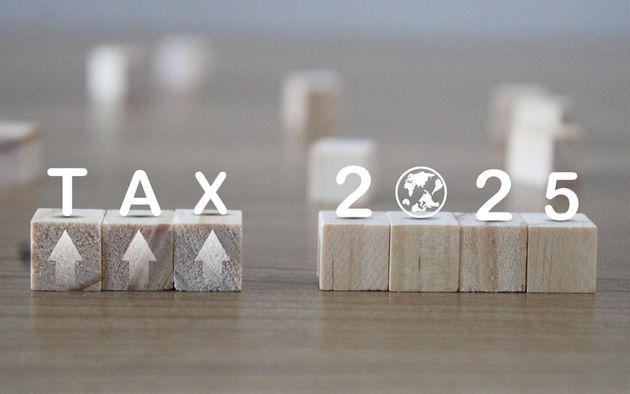 Tax 2025 concept with wooden blocks and letters.