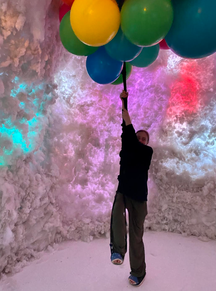 The author’s daughter swings from balloons in her casts.