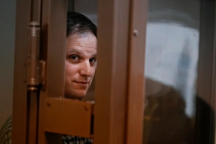 Wall Street Journal reporter Evan Gershkovich stands in a defendant's booth during a hearing in Moscow on April 18, 2023.