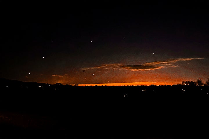 This photo provided by Trisha Bushey shows the evening sky and points of light near in Lebanon Township, N.J., on Thursday, Dec. 5, 2024. (Trisha Bushey via AP)