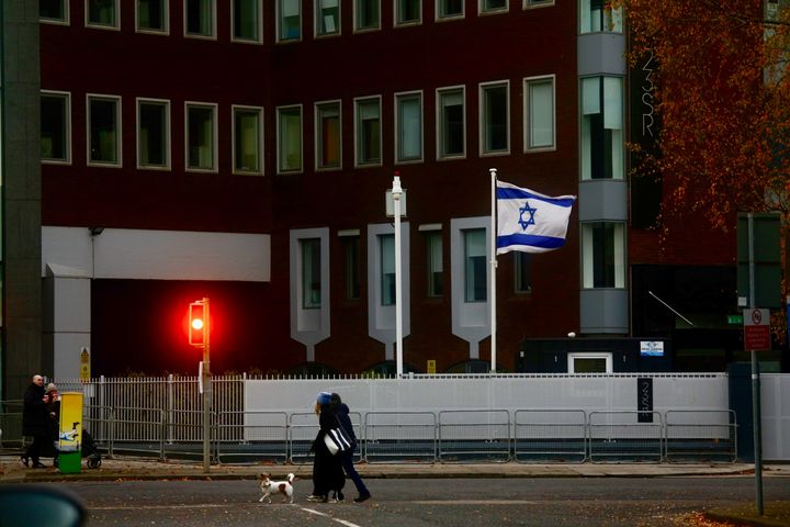 People are seen walking with their pets in front of the Embassy of Israel to Ireland, which was announced closed in Dublin on Dec. 15, 2024. 