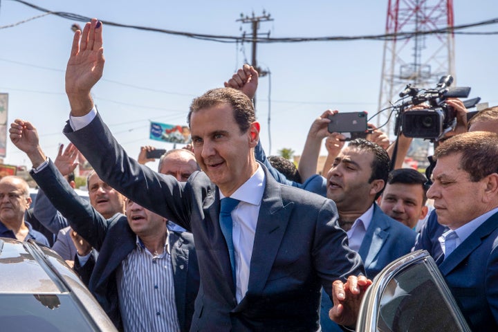 Former Syrian president Bashar al-Assad waves to his supporters in 2021.