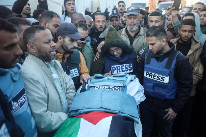 Mourners, including colleagues, attend the funeral of Al Jazeera video journalist Ahmed Al-Louh after an Israeli strike on Al-Aqsa Martyrs Hospital's civil emergency center killed him, in central Gaza's Deir Al-Balah on Dec. 16, 2024.