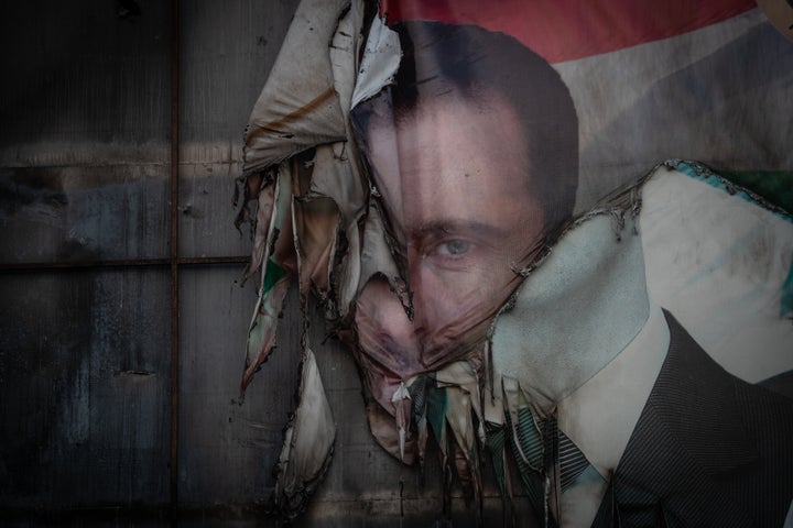 A damaged poster of former Syrian President Bashar al-Assad is seen on a billboard on Dec. 14, 2024 in Aleppo, Syria. Aleppo was the first major city to fall in last week's lightning offensive by rebel forces as they toppled Syria's Assad regime.