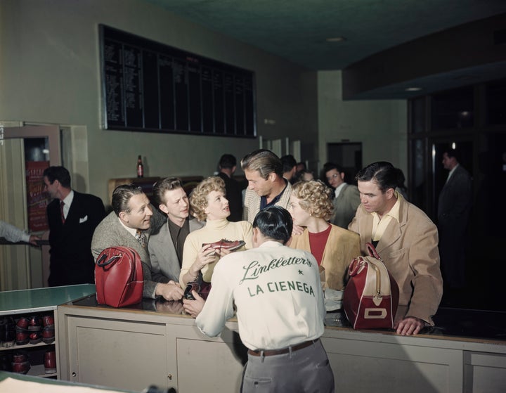 Though they're not nearly as popular these days, bowling alleys used to be a thriving third space in the U.S. Pictured here is American radio and television personality Art Linkletter (left), circa 1955, with a group of people at Linkletter's La Cienega Lanes bowling alley, which was on the corner of Santa Monica Boulevard and La Cienega Boulevard in West Hollywood, California.