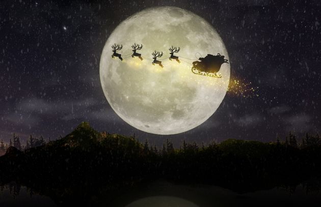 Santa Claus rides on their reindeer cart.Fly over the forest through the big moon.