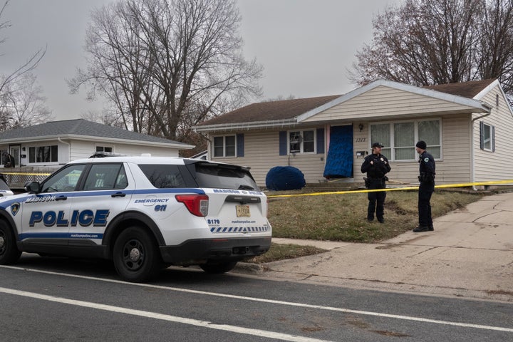 Police stand guard on Tuesday outside the home of 15-year-old accused of carrying out the school shooting in Madison.