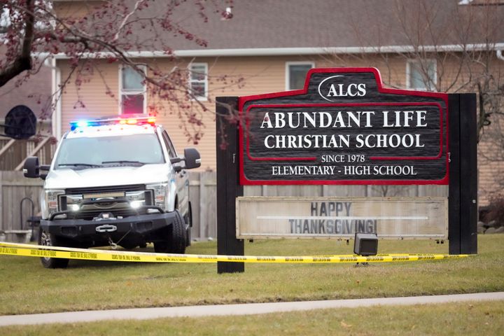 An emergency vehicle is parked outside the Abundant Life Christian School in Madison on Monday.