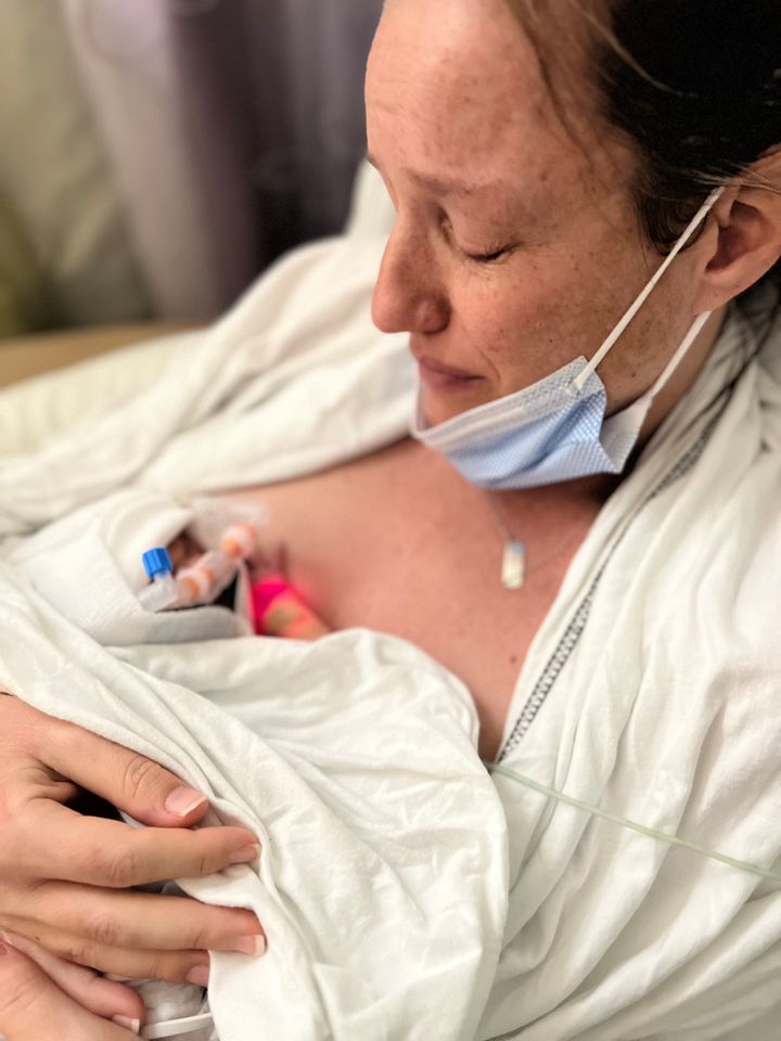 The author holds her son Jacob for the very first time in the neonatal intensive care unit on Jan. 9.