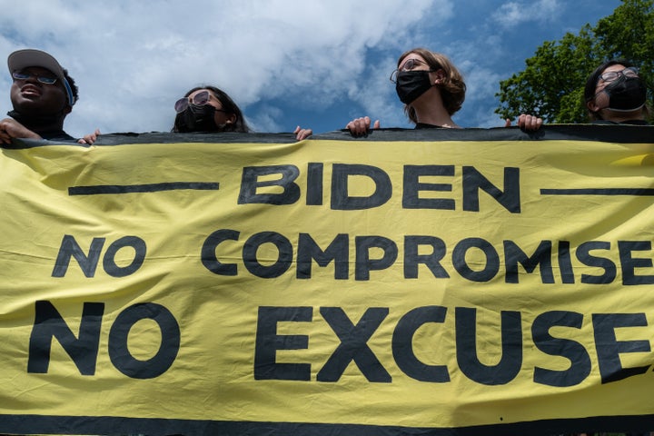 Members of the Sunrise Movement hold a banner while protesting near the White House on June 4, 2021.