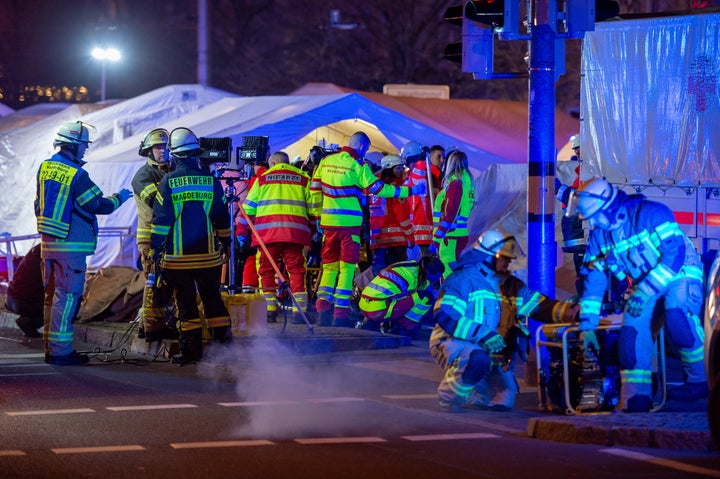 Police vans and ambulances stand next to the annual Christmas market in the city center after a car plowed into the Christmas market on December 20, 2024 in Magdeburg, Germany.