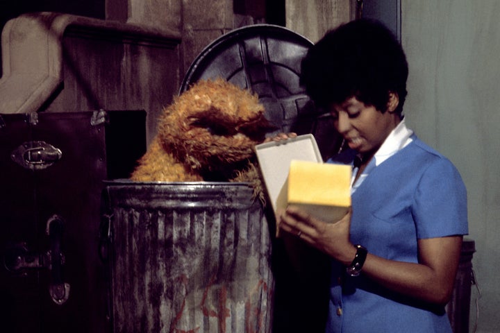 Oscar the Grouch and performer Loretta Long during the taping of the first season of "Sesame Street" in March 1970 in New York City.