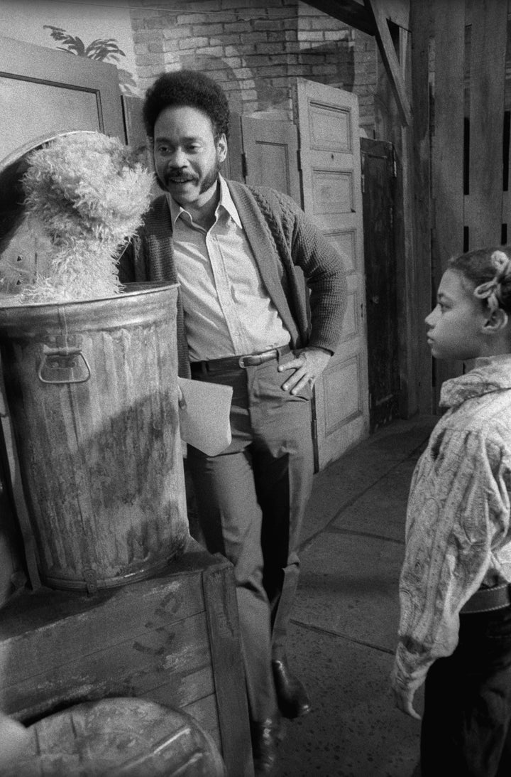 Performer Matt Robinson talks to Oscar the Grouch as a child looks on during the taping of an episode of "Sesame Street" in March 1970.