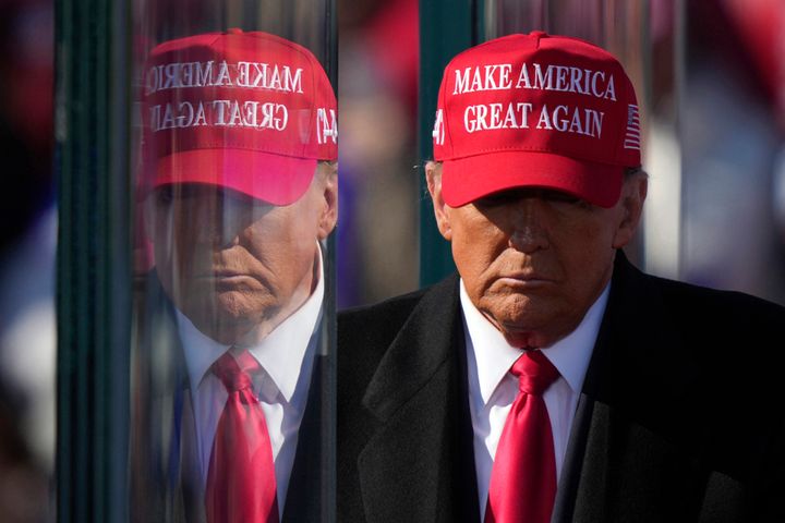 Donald Trump is reflected in the bullet proof glass as he finishes speaking at a campaign rally in Lititz, Pa., Nov. 3, 2024. (AP Photo/Matt Rourke, File)