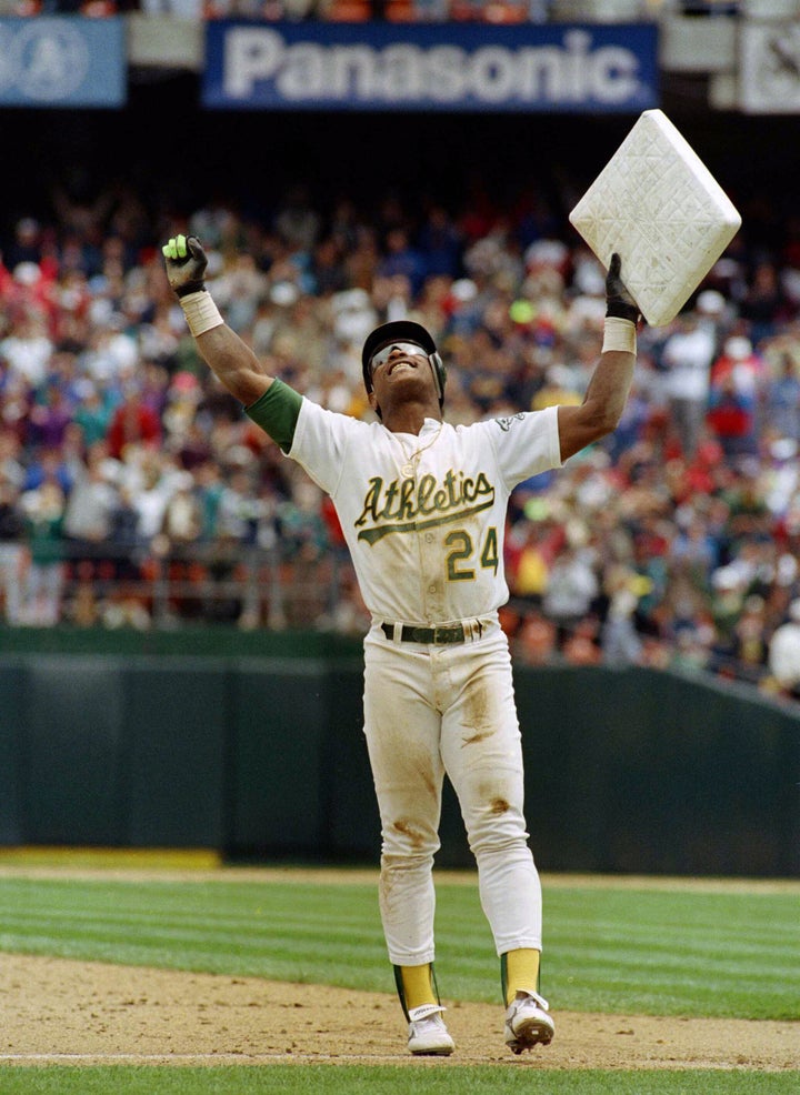 In this photo taken May 1, 1991, Henderson holds up third base in celebration after setting the all-time stolen base record during an Athletics' baseball game in Oakland, California, against the New York Yankees.