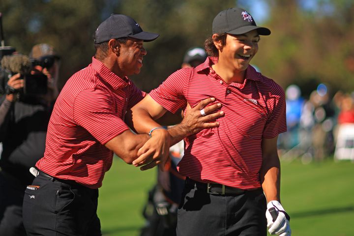 Tiger Woods reacts with son Charlie Woods after holing out on the fourth hole during the second round of the PNC Championship at Ritz-Carlton Golf Club on Sunday in Orlando, Florida.