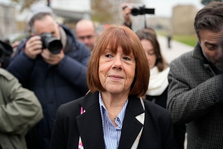 Gisèle Pelicot arrives with her lawyer, Antoine Camus, in front of the courthouse before a verdict in the Pelicot case is delivered on Dec. 19 in Avignon, France. Pelicot's ex-husband and 51 other men were charged with raping her over a multiyear period, in encounters arranged by her then-husband while she was drugged and unconscious.