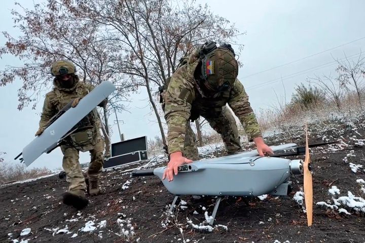 Russian servicemen assemble a drone at an undisclosed location. (Russian Defense Ministry Press Service via AP)