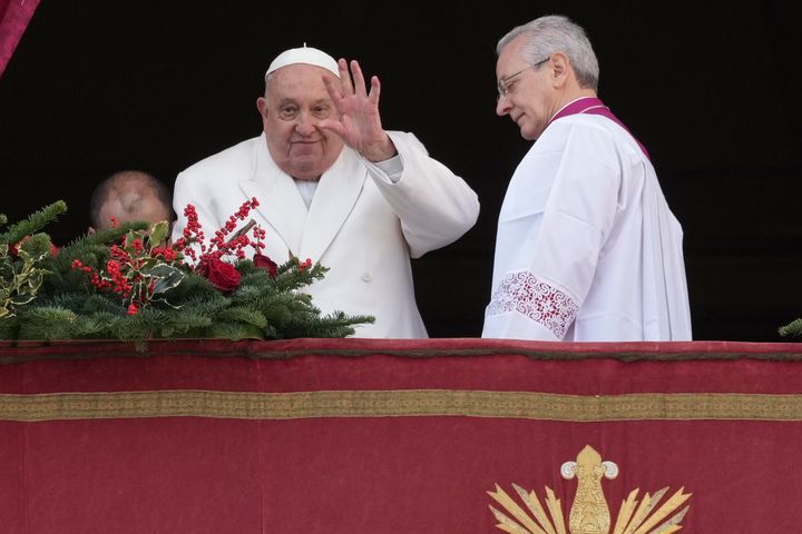 Pope Francis waves before delivering the Urbi et Orbi (Latin for 'to the city and to the world' ) Christmas' day blessing from the main balcony of St. Peter's Basilica at the Vatican, Wednesday, Dec. 25, 2024. (AP Photo/Andrew Medichini)