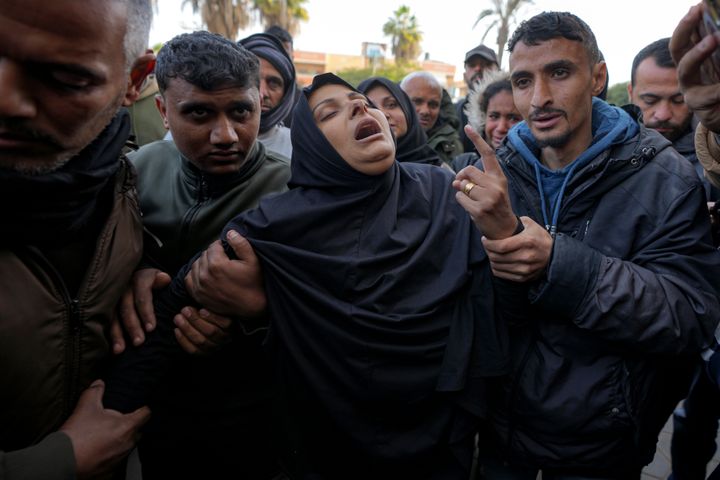 A woman reacts during the funeral of five Palestinian journalists who were killed by an Israeli airstrike in Gaza City at the Al-Aqsa Hospital in Deir al-Balah, Thursday, Dec. 26, 2024. (AP Photo/Abdel Kareem Hana)