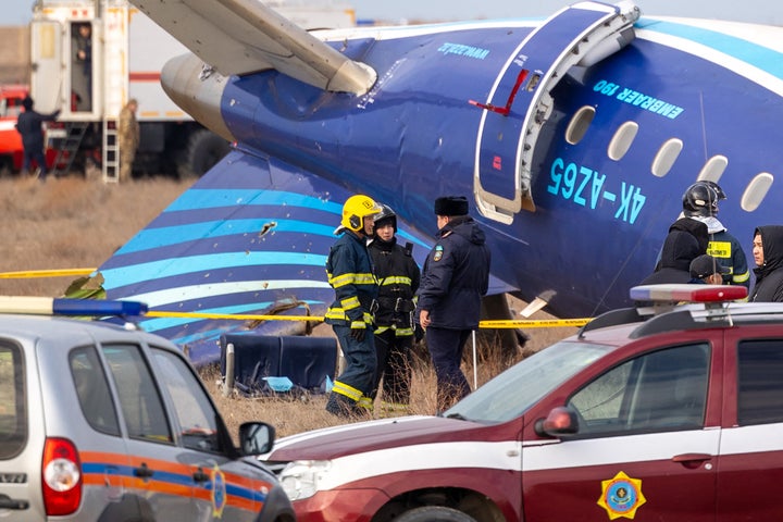 Emergency specialists work at the crash site of an Azerbaijan Airlines passenger jet near the western Kazakh city of Aktau on December 25, 2024. (Photo by Issa Tazhenbayev / AFP via Getty Images)