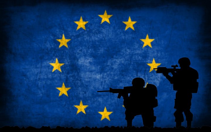 Soldiers with guns silhouette with the national flag on the background - European Union