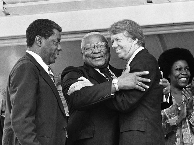 The Rev. Dr. Martin Luther King Sr. (center) and Democratic presidential candidate Jimmy Carter (right) embrace during a campaign rally where King declared, 