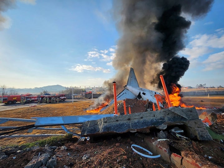 In this photo provided by South Korea's Muan Fire Station, a passenger plane is in flames at the Muan International Airport in Muan, South Korea, on Dec. 29, 2024.