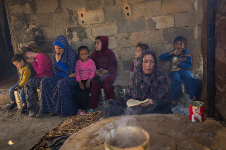 Amal Al-Jali, a 46-year-old mother of 14 displaced from Gaza City, prepares bread at a camp for displaced Palestinians in Deir al-Balah, Gaza Strip, on Nov. 7, 2024.