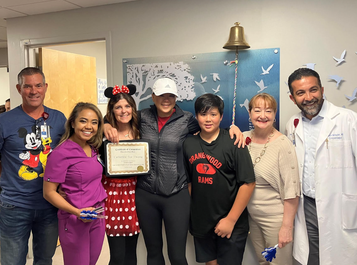 The author celebrating the end of chemotherapy with her doctors, friends and one of her sons.