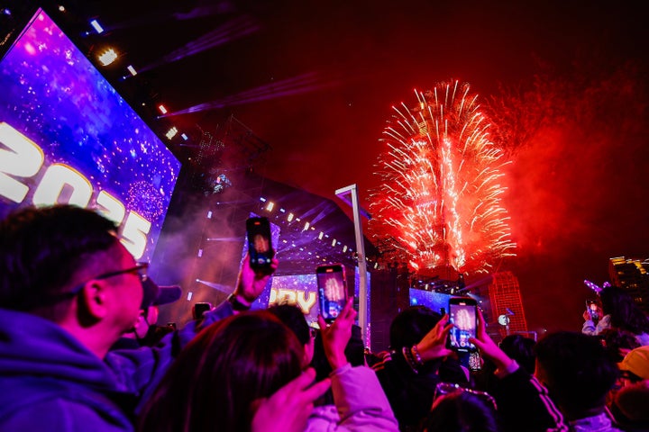 People watch fireworks released from landmark Taipei 101 to embrace the new year of 2025, in Taipei, Taiwan, on January, 1, 2025. (Photo by Daniel Ceng/Anadolu via Getty Images)