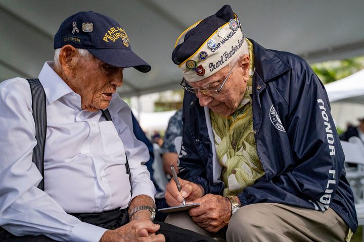 Pearl Harbor survivors Harry Chandler, 102, left, and Herb Elfring, 101, talk during the 82nd Pearl Harbor Remembrance Day ceremony on Dec. 7, 2023, at Pearl Harbor in Honolulu. (AP Photo/Mengshin Lin, File)