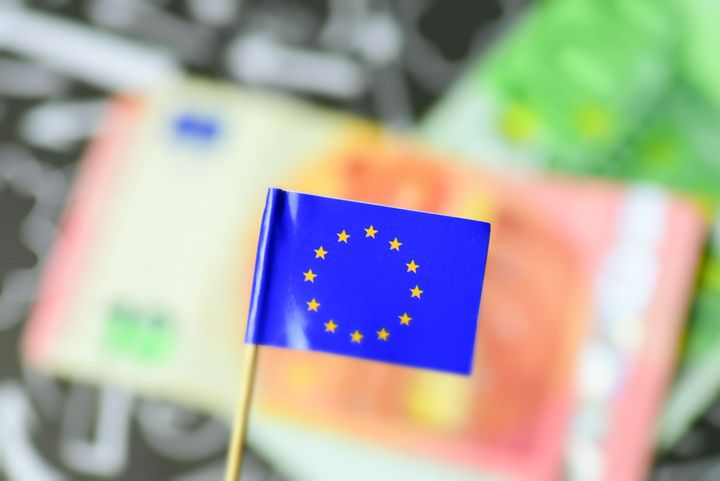 Flag of the European Union EU and euro banknotes in the background