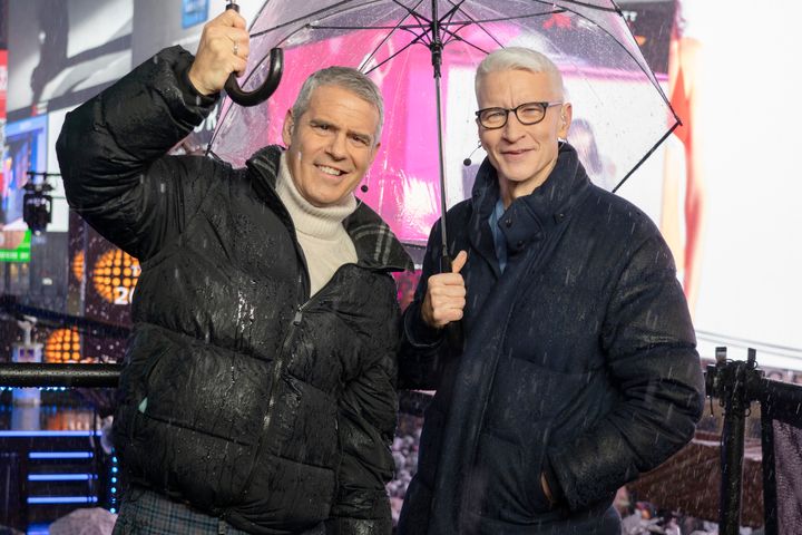 Andy Cohen and Anderson Cooper host CNN's New Year's Eve coverage in the rain in Times Square on Tuesday in New York City.