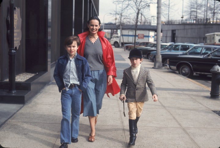 A young Anderson Cooper wears an English horse riding getup while strolling New York City with his late mother, Gloria Vanderbilt, and late brother Carter in 1976.