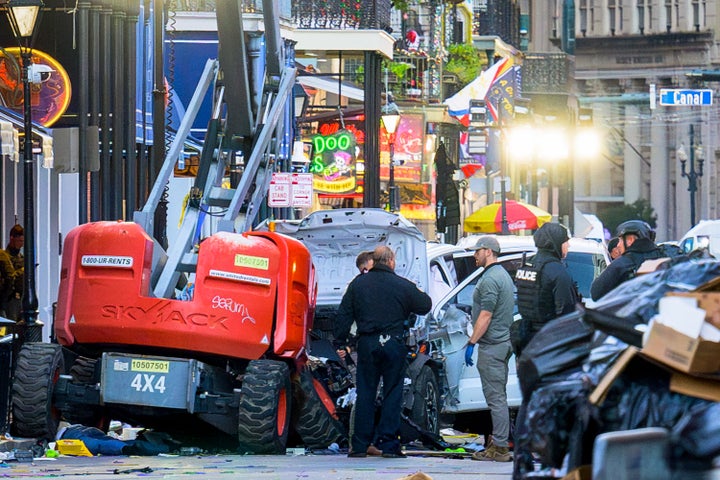 Police investigators surround the white Ford F-150 pickup truck that crashed into a work lift after driving into a crowd of New Year's revelers in New Orleans, Louisiana, on Jan. 1, 2025.