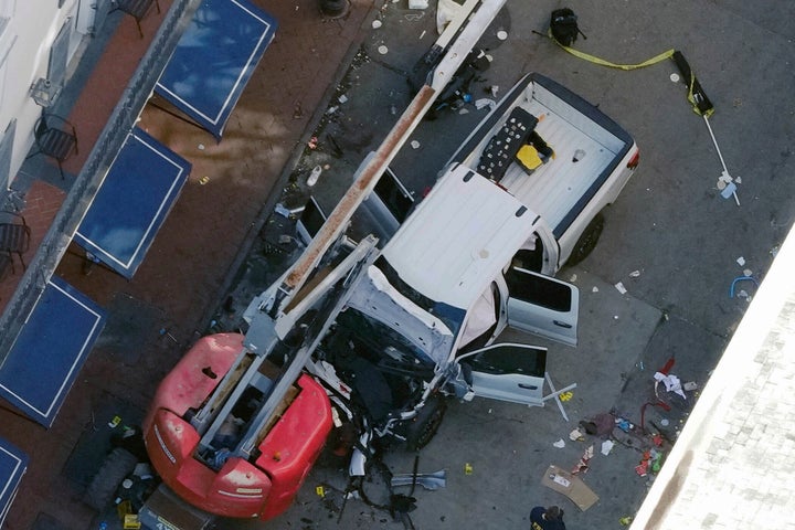 FILE - A black flag with white lettering lies on the ground rolled up behind a pickup truck that a man drove into a crowd on Bourbon Street in New Orleans, killing and injuring a number of people, early Wednesday morning, Jan. 1, 2025. (AP Photo/Gerald Herbert, File)