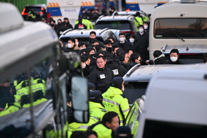 Police and investigators arrive at the residence of South Korea's impeached President Yoon Suk Yeol in Seoul on January 3, 2025. South Korean investigators arrived outside the presidential residence early Friday seeking to arrest Yoon Suk Yeol, with the impeached leader's die-hard supporters massing outside to protect him, AFP reporters saw. Cars carrying investigators probing Yoon's short-lived declaration of martial law drove up to his residence in central Seoul, which was surrounded by a heavy police presence, AFP saw. Yoon would become the first sitting president in South Korean history to be arrested. (Photo by JUNG Yeon-je / AFP) (Photo by JUNG YEON-JE/AFP via Getty Images)