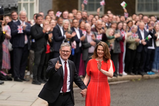 Keir Starmer and his wife, Victoria, walk up Downing Street on the day he became prime minister.