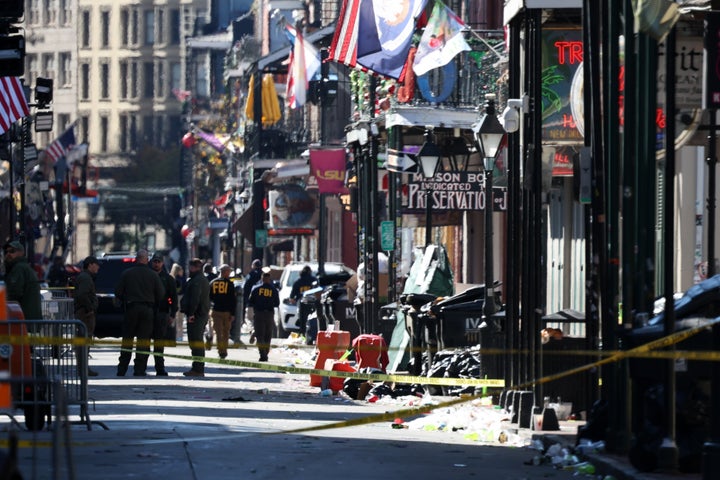 Members of the FBI and New Orleans Police work the scene on Bourbon Street after more than a dozen people were killed and injured after a person drove a pickup truck into the crowded street.