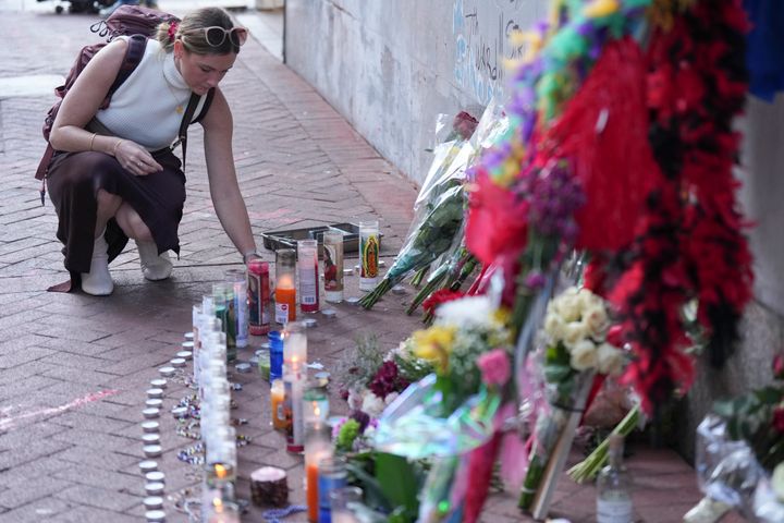 A woman visits a memorial to the victims of a deadly truck attack on Bourbon Street in New Orleans on Friday.