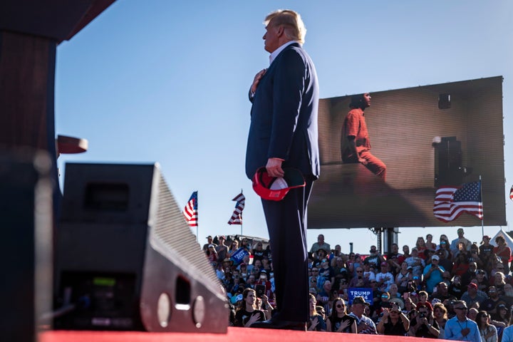 Former President Donald Trump listens as video from the Jan. 6, 2021, insurrection at the U.S. Capitol is shown while the song, "Justice for All," is played during a campaign rally at the Waco Regional Airport on Saturday, March 25, 2023, in Waco, Texas. 