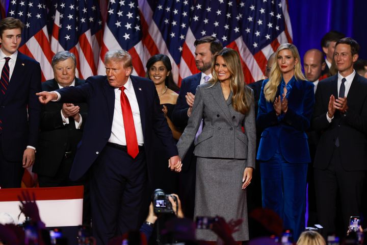 Donald Trump points to supporters with former first lady Melania Trump during an election night event at the Palm Beach Convention Center on November 06, 2024 in West Palm Beach, Florida. (Photo by Joe Raedle/Getty Images)