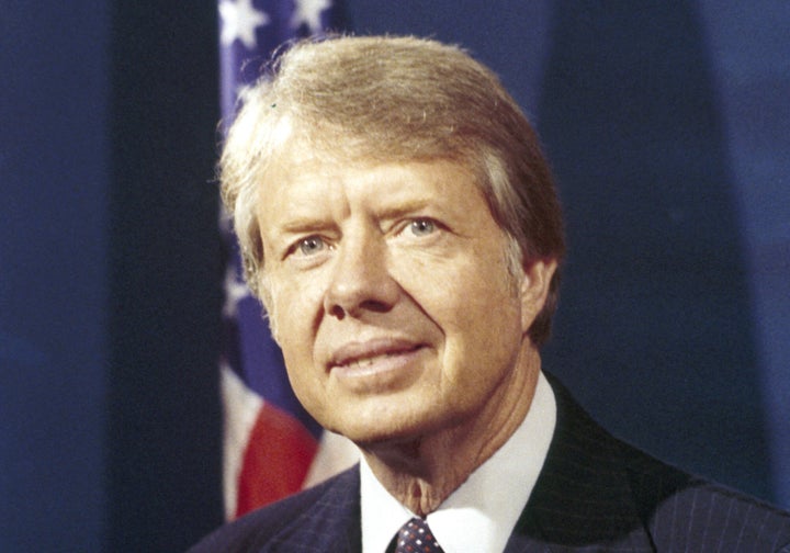 Jimmy Carter poses for photographers after sitting for his official portrait at his home in Plains, Georgia, on Dec. 5, 1976. Carter assumed office January 20, 1977.